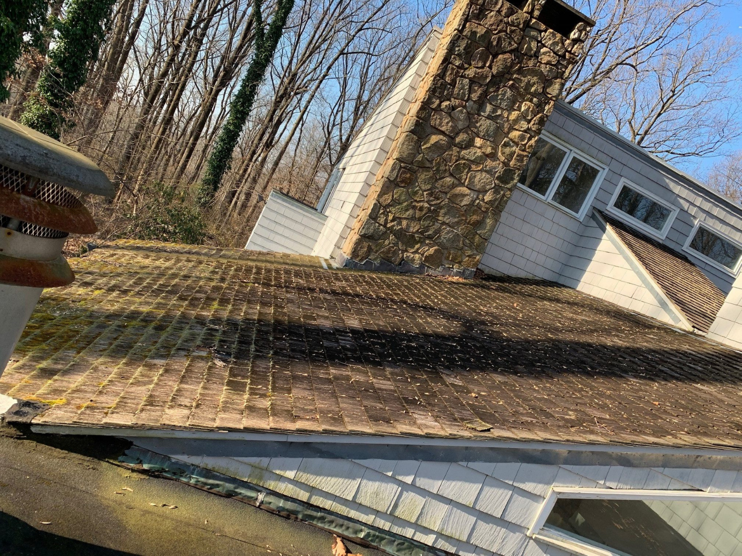 Worn shingles and a deteriorated roof edge that require inspection