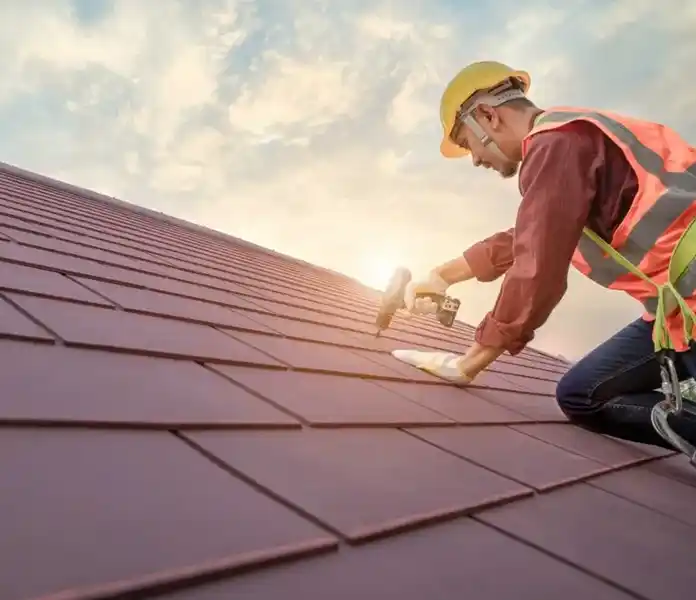 Roofer installing roofing tiles