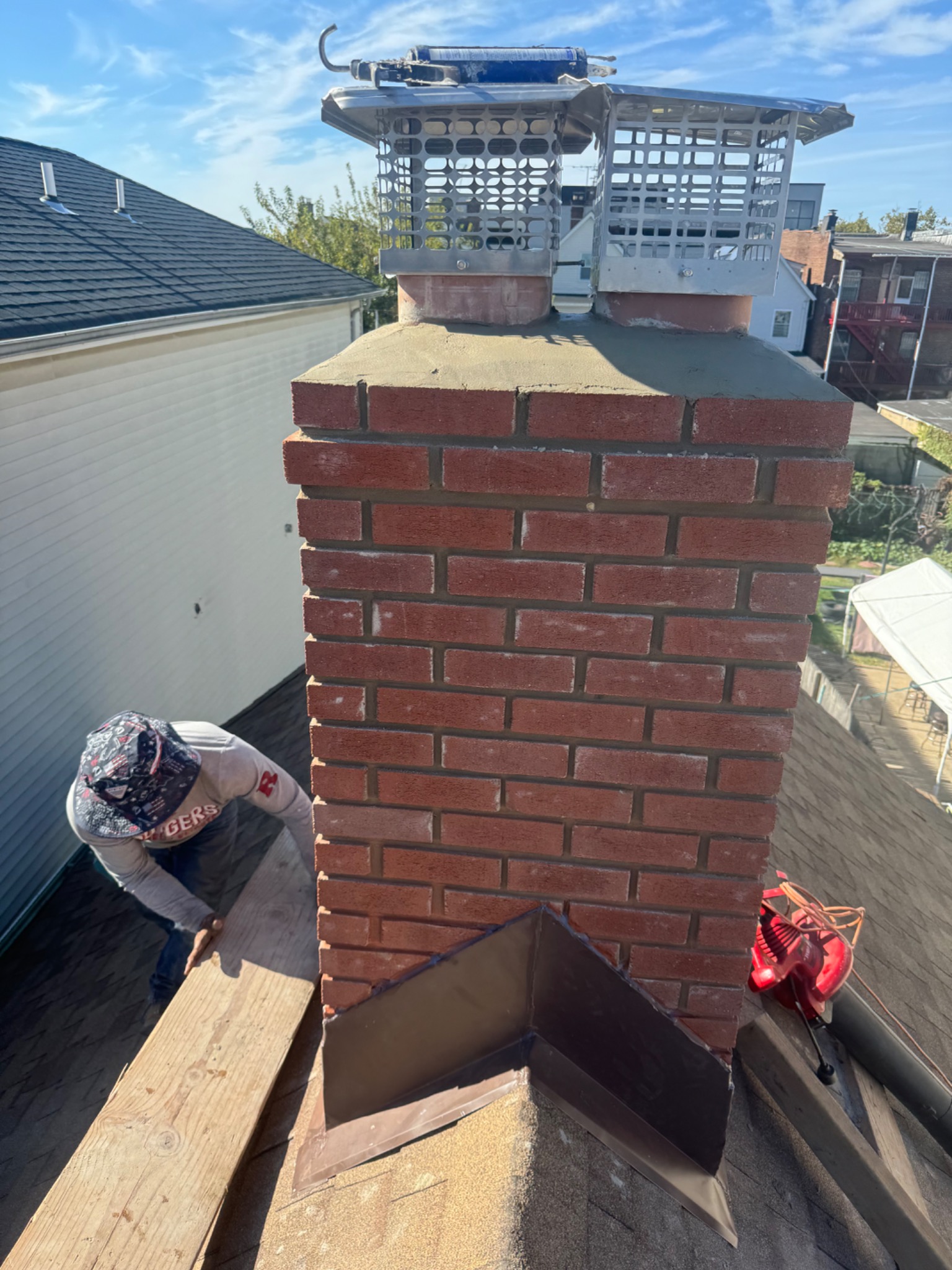 Rebuilt brick chimney with crown, caps and roof flashing in a Golden Master project